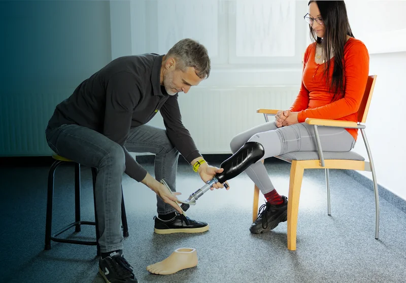 Orthopädietechniker passt Beinprothese an – individuelle Versorgung und präzise Anpassung im Beratungsgespräch